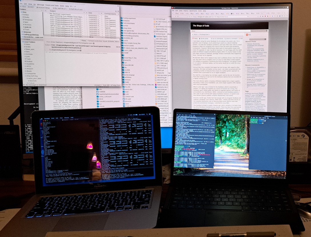 MacBook, StarBook and Samsung 32inch curved monitor.